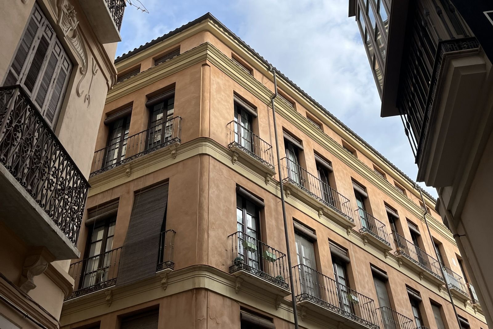 Traditional apartment building with balconies in Malaga city centre