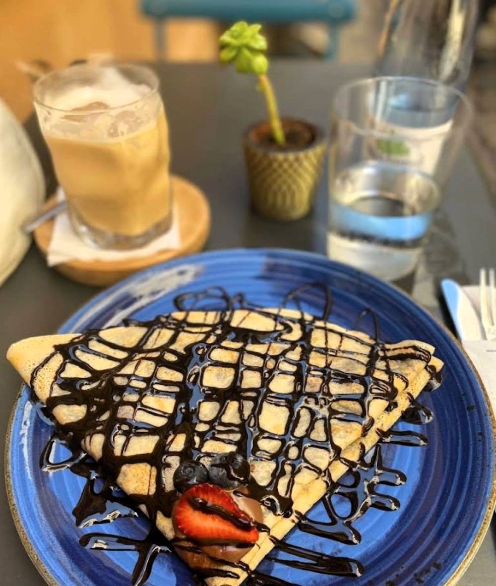Outdoor terrace at Mala Leche coffee shop in Malaga